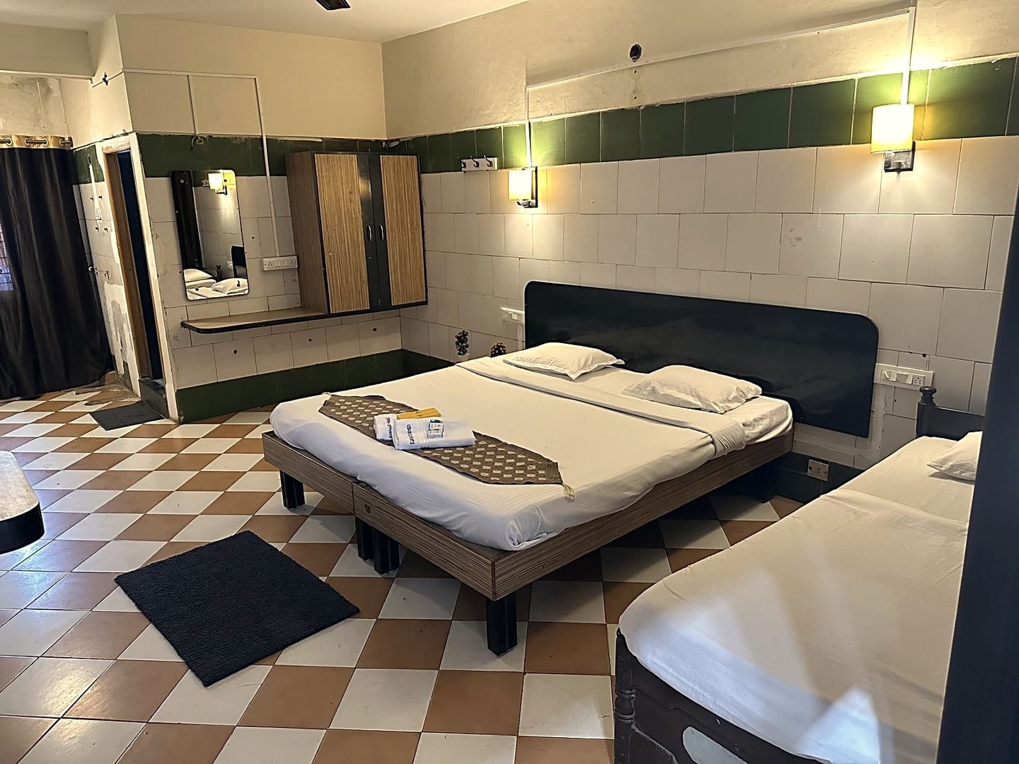 Premium room set up with an extra bed for a third guest